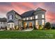 Stunning stone home with turret, manicured lawn, and inviting front entrance at 920 Terramore Dr, Waxhaw, NC 28173