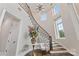 Grand foyer with a curved staircase, high ceilings, and a beautiful chandelier at 920 Terramore Dr, Waxhaw, NC 28173