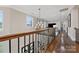 Upstairs hallway with hardwood floors, decorative lighting, and an open view to a living space at 920 Terramore Dr, Waxhaw, NC 28173