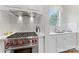 Kitchen nook boasts a professional range, custom vent hood and marble tiling at 920 Terramore Dr, Waxhaw, NC 28173