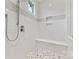 This shower features a pebble floor, built in bench, and white subway tiling at 920 Terramore Dr, Waxhaw, NC 28173