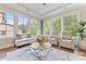 Cozy sunroom featuring comfortable seating, neutral colors, and views of the surrounding greenery at 920 Terramore Dr, Waxhaw, NC 28173