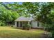 View of the back of a single-story home with a screened porch and a fenced yard, great for outdoor living at 10016 Heathergate Ln, Mint Hill, NC 28227