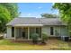 Back exterior view shows a screened porch and backyard with an air conditioning unit at 10016 Heathergate Ln, Mint Hill, NC 28227