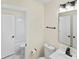 Bright bathroom with a shower-tub combo, toilet, and vanity with black hardware at 10016 Heathergate Ln, Mint Hill, NC 28227