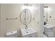 Well-lit bathroom featuring an oval mirror over a white sink with a modern faucet at 10016 Heathergate Ln, Mint Hill, NC 28227
