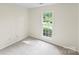 Bright bedroom with neutral carpet and a view of the neighborhood from the window at 10016 Heathergate Ln, Mint Hill, NC 28227