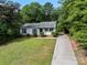 Lovely one-story home with well-kept landscaping and a long driveway, providing ample parking space at 10016 Heathergate Ln, Mint Hill, NC 28227
