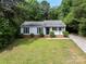 Charming single-story home features a well-manicured lawn, black shutters, and a welcoming front entrance at 10016 Heathergate Ln, Mint Hill, NC 28227