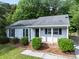 Charming single-story home with a well-maintained front yard, mature trees, and brick-accented entryway at 10016 Heathergate Ln, Mint Hill, NC 28227