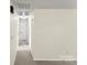 Hallway featuring new carpet, neutral paint, and multiple doorways for easy access to other rooms at 10016 Heathergate Ln, Mint Hill, NC 28227