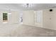 Bright living room with neutral carpet and paint, complemented by modern lighting fixtures and natural light at 10016 Heathergate Ln, Mint Hill, NC 28227