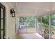 Enclosed sunroom with views of the lush, green backyard, with a cooling unit at 10016 Heathergate Ln, Mint Hill, NC 28227