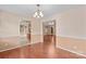 Dining room featuring wood-look flooring, neutral paint, and an elegant chandelier at 103 Prestwick Ct, Salisbury, NC 28146