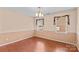 Dining room with wood-look flooring and neutral paint, featuring chandelier at 103 Prestwick Ct, Salisbury, NC 28146