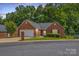 Charming one-story brick home featuring an attached garage and a well-manicured front yard at 103 Prestwick Ct, Salisbury, NC 28146