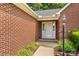 Close-up of front brick entry of home; nicely landscaped with shrubs and mulch at 103 Prestwick Ct, Salisbury, NC 28146