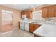 Traditional kitchen featuring wooden cabinets, white appliances, and a window overlooking the backyard at 103 Prestwick Ct, Salisbury, NC 28146