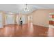 Open living room boasts vaulted ceilings, ceiling fan, and wood-look flooring at 103 Prestwick Ct, Salisbury, NC 28146