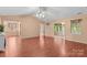 Bright, open living room with vaulted ceiling, fan, and wood-look laminate flooring at 103 Prestwick Ct, Salisbury, NC 28146