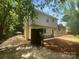 Exterior angle showing the home's backyard with brick and wooden fencing, landscaping, and driveway at 10931 Osprey Dr, Charlotte, NC 28226