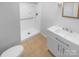Bathroom featuring a walk-in shower with white tile, modern fixtures, vanity, and toilet at 10931 Osprey Dr, Charlotte, NC 28226