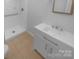 Bathroom features a sleek white vanity, ceramic tile flooring, and a glass-enclosed shower at 10931 Osprey Dr, Charlotte, NC 28226