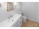 Bathroom featuring a white vanity with modern fixtures and a toilet at 10931 Osprey Dr, Charlotte, NC 28226