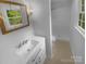 Bright bathroom features a shower, vanity with modern fixtures, and a window at 10931 Osprey Dr, Charlotte, NC 28226