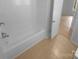 Clean bathroom with a shower and tub combination and neutral tile flooring at 10931 Osprey Dr, Charlotte, NC 28226