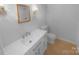 Bathroom featuring a white vanity with modern fixtures and a toilet at 10931 Osprey Dr, Charlotte, NC 28226