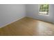 Bedroom featuring hardwood floors, white trim, and a view from a double window at 10931 Osprey Dr, Charlotte, NC 28226