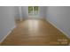 Spacious bedroom with light-colored hardwood floors, bright white trim, and windows at 10931 Osprey Dr, Charlotte, NC 28226