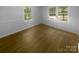 Bright bedroom features hardwood floors and sunny windows overlooking the surrounding landscape at 10931 Osprey Dr, Charlotte, NC 28226