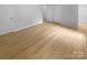 Bright, empty bedroom with hardwood floors, white walls and trim, closet and space for multiple uses at 10931 Osprey Dr, Charlotte, NC 28226