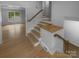 Bright entryway features hardwood floors, natural wood stairs and trim, and leads to a living space at 10931 Osprey Dr, Charlotte, NC 28226