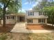 Charming two-story home features a brick and gray facade, welcoming entrance, and landscaped front yard at 10931 Osprey Dr, Charlotte, NC 28226