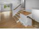 Bright foyer showcases hardwood stairs with white risers and views into another room at 10931 Osprey Dr, Charlotte, NC 28226