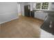 Kitchen with stainless steel appliances, white cabinets, and tile flooring is bright and spacious at 10931 Osprey Dr, Charlotte, NC 28226