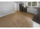 Bright kitchen with stainless appliances, white cabinets, tile floors, and an open floor plan at 10931 Osprey Dr, Charlotte, NC 28226