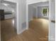 Open concept with living room, kitchen with white cabinetry, and lots of natural light at 10931 Osprey Dr, Charlotte, NC 28226
