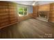 Living room with wood-look floors and a fireplace with built-in shelving at 10931 Osprey Dr, Charlotte, NC 28226