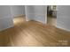 Open floorplan features light-colored hardwood floors, bright white trim and walls at 10931 Osprey Dr, Charlotte, NC 28226
