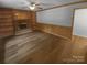 Inviting living room with hardwood floors, brick fireplace, built in shelving, and wainscoting at 10931 Osprey Dr, Charlotte, NC 28226