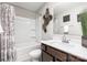 Bathroom features a shower-tub combo, with neutral walls and flooring at 1117 Laurel Woods Dr, Gastonia, NC 28052