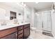Bathroom with double sinks, dark wood cabinets, and a walk-in glass shower, offering comfort and style at 1117 Laurel Woods Dr, Gastonia, NC 28052