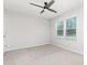 This bedroom has neutral colored walls and carpeting, as well as a ceiling fan at 1117 Laurel Woods Dr, Gastonia, NC 28052