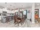 Dining area featuring wooden table, decorative lighting, and a view to the kitchen with barstool seating at 1117 Laurel Woods Dr, Gastonia, NC 28052