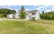 Charming two-story home with white siding, a well-manicured lawn, and mature trees at 1117 Laurel Woods Dr, Gastonia, NC 28052