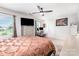 Bright main bedroom with a ceiling fan, TV, and a desk area with great natural light at 1117 Laurel Woods Dr, Gastonia, NC 28052